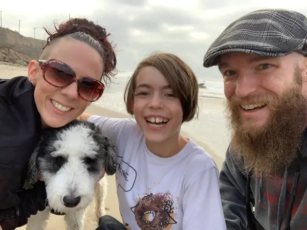 Dr. Matt's family and dog on the beach
