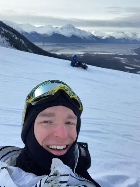Dr. Matt snowboarding in the mountains with his son